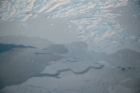 Ice forms on the window of an airplane heading from Iqaluit to Pond Inlet, Nunavut, Canada. The Earth's poles are warming faster than elsewhere, with the North Pole heating up about twice as fast as the rest of Earth for the last 30 years. | Bloomberg