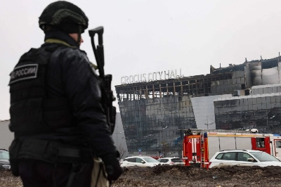 A law enforcement officer patrols the scene of the deadly attack at the Crocus City Hall concert hall in Krasnogorsk, outside Moscow, on Saturday. A law enforcement officer patrols the scene of the deadly attack at the Crocus City Hall concert hall in Krasnogorsk, outside Moscow, on Saturday.