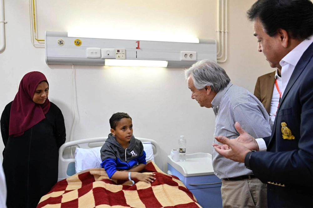 U.N. Secretary-General Antonio Guterres meets with a Palestinian child evacuated from the Gaza Strip at a hospital in El-Arish, Egypt, on Saturday.  U.N. Secretary-General Antonio Guterres meets with a Palestinian child evacuated from the Gaza Strip at a hospital in El-Arish, Egypt, on Saturday.