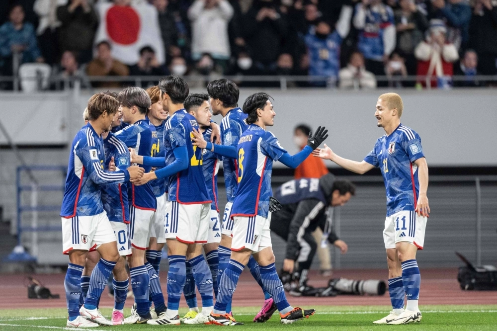 Japanese players celebrate a goal during their World Cup qualifying match against North Korea on Thursday in Tokyo.  Japanese players celebrate a goal during their World Cup qualifying match against North Korea on Thursday in Tokyo.