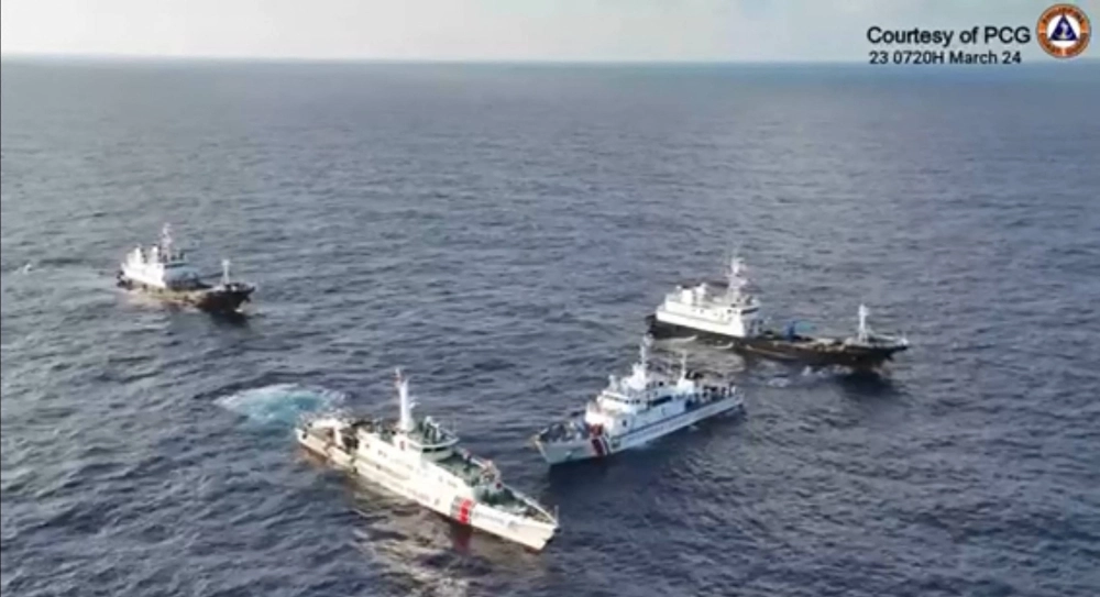 A screenshot from a video taken and released Saturday shows China Coast Guard ships and Chinese maritime militia boats surrounding a Philippine Coast Guard ship during a resupply mission near Second Thomas Shoal in the waters of the disputed South China Sea on Saturday. A screenshot from a video taken and released Saturday shows China Coast Guard ships and Chinese maritime militia boats surrounding a Philippine Coast Guard ship during a resupply mission near Second Thomas Shoal in the waters of the disputed South China Sea on Saturday.