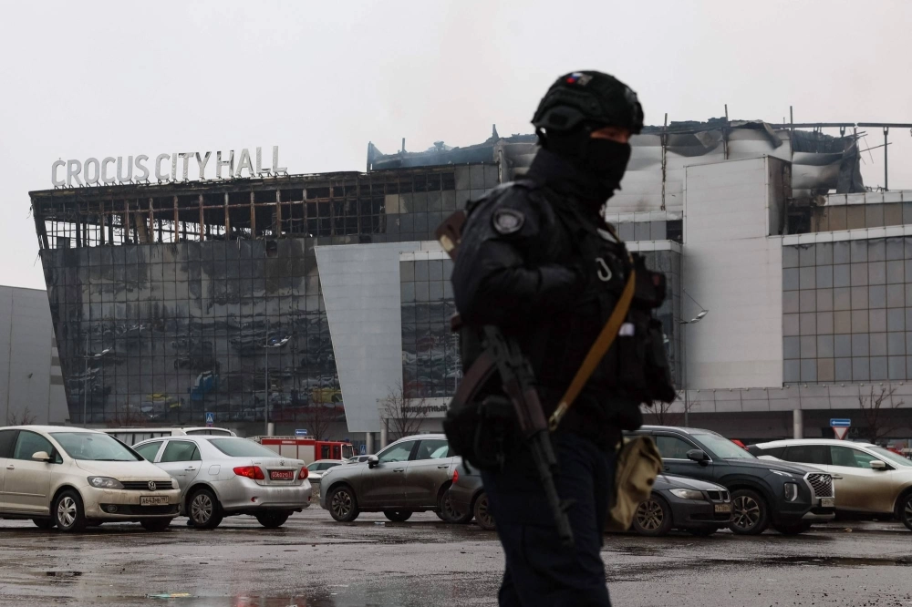A law enforcement officer patrols the scene of the gun attack at the Crocus City Hall in Krasnogorsk, outside Moscow, on Saturday. A law enforcement officer patrols the scene of the gun attack at the Crocus City Hall in Krasnogorsk, outside Moscow, on Saturday.