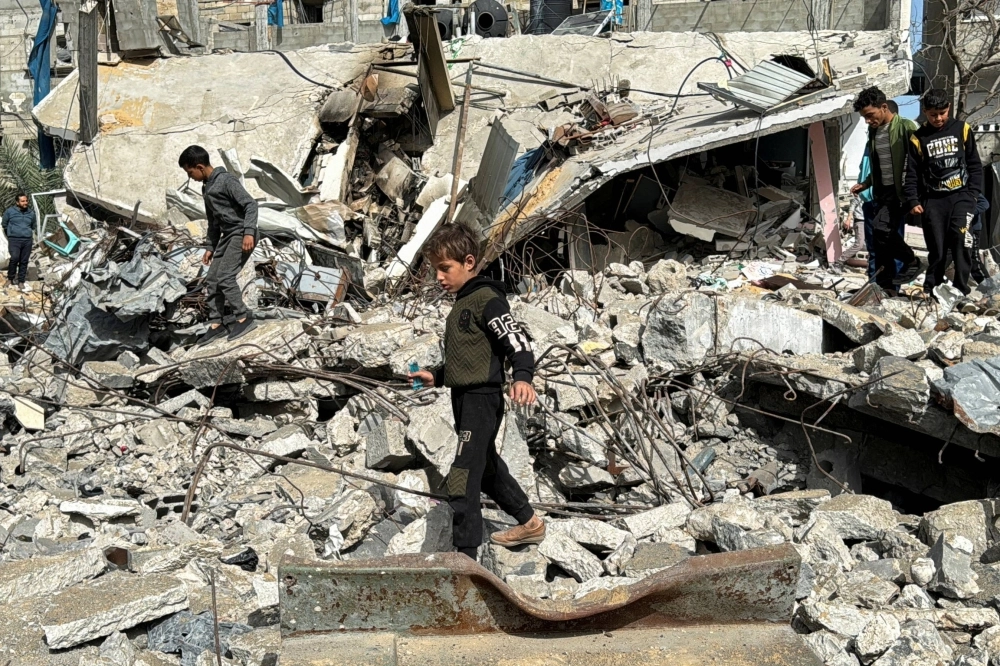 A Palestinian boy walks on the site of an Israeli strike in Rafah, in the southern Gaza Strip, on March 27. A Palestinian boy walks on the site of an Israeli strike in Rafah, in the southern Gaza Strip, on March 27.