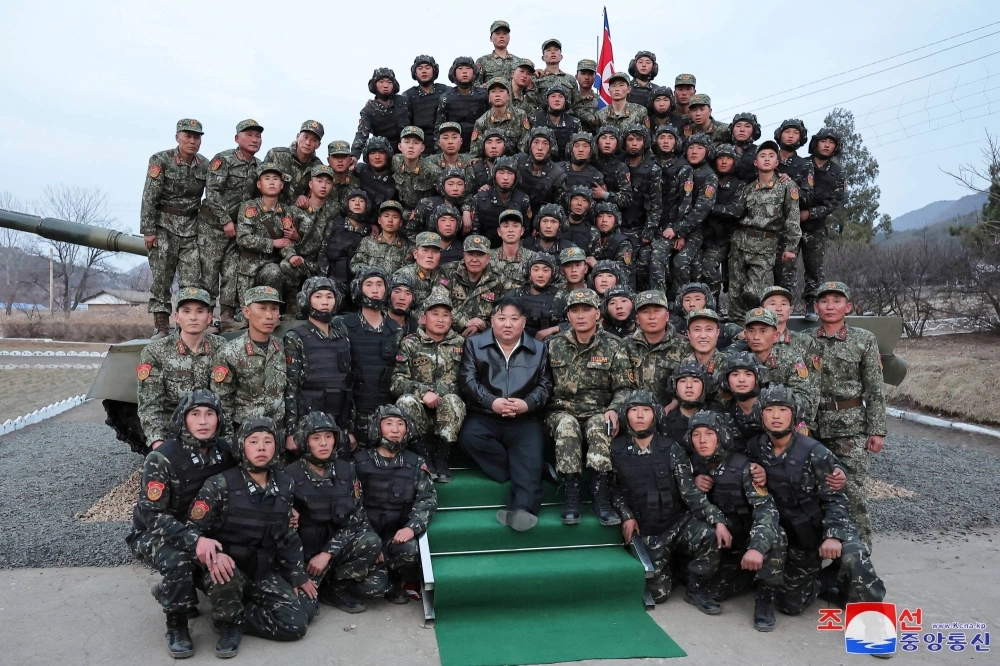 Kim poses with soldiers after inspecting a tank unit of the Korean People's Army, in this handout picture obtained by Reuters on March 25. With a 1.1 million-strong active-duty army, North Korea has a manpower advantage, but the bulk of its forces rely on Kim poses with soldiers after inspecting a tank unit of the Korean People's Army, in this handout picture obtained by Reuters on March 25. With a 1.1 million-strong active-duty army, North Korea has a manpower advantage, but the bulk of its forces rely on