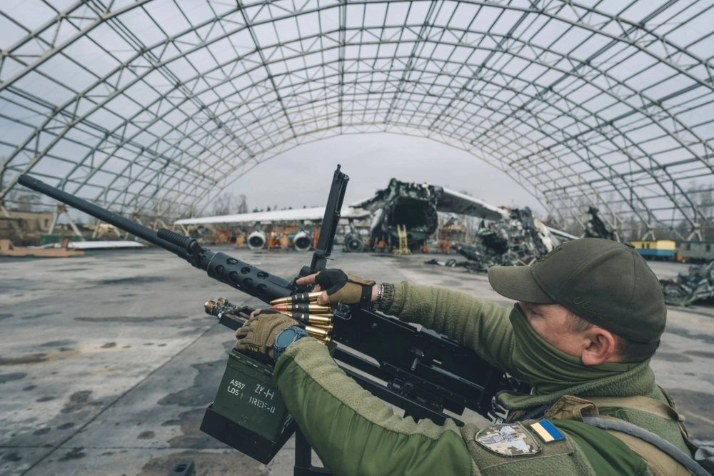 A Ukrainian soldier loads ammunition into an M2 Browning machine gun.  A Ukrainian soldier loads ammunition into an M2 Browning machine gun.