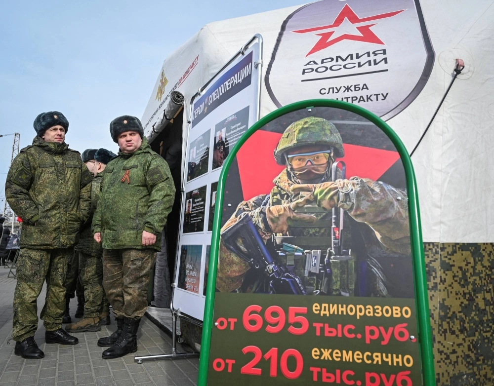 Russian Army servicemen stand near a mobile recruiting center in Rostov-on-Don, Russia, on Wednesday.  Russian Army servicemen stand near a mobile recruiting center in Rostov-on-Don, Russia, on Wednesday.