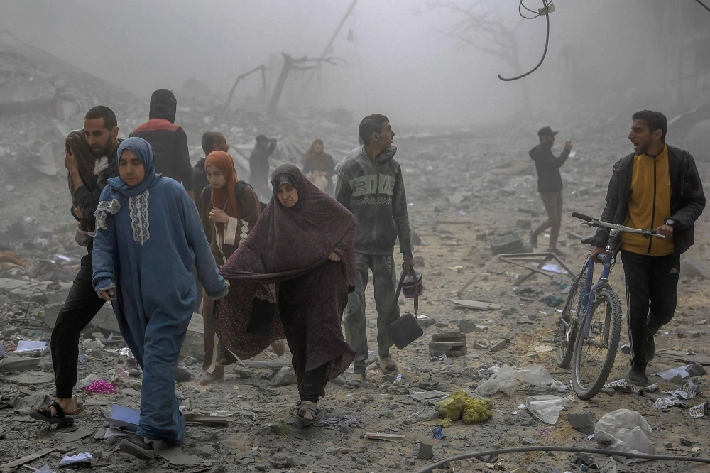 Palestinians flee an area in central Gaza City after Israeli bombardment in March. U.S. President Joe Biden said an "immediate” cease-fire is necessary to improve the humanitarian situation in Gaza. Palestinians flee an area in central Gaza City after Israeli bombardment in March. U.S. President Joe Biden said an "immediate” cease-fire is necessary to improve the humanitarian situation in Gaza.