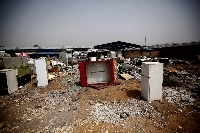 Broken fridges in the yard of a recycling workers' tenement house in Dongxiaokou village in Beijing in 2014 | REUTERS