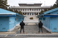 South Korean soldiers stand guard in the truce village of Panmunjom inside the demilitarized zone separating South and North Korea. | Bloomberg