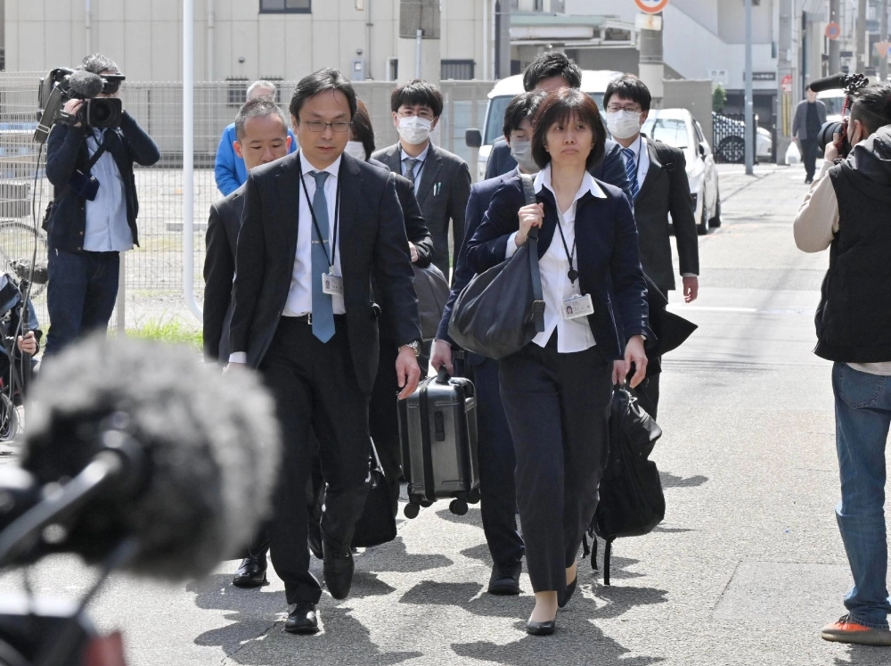 Health ministry officials head to a Kobayashi Pharmaceutical factory in the city of Osaka on March 30 to conduct a search of the premises. Health ministry officials head to a Kobayashi Pharmaceutical factory in the city of Osaka on March 30 to conduct a search of the premises.