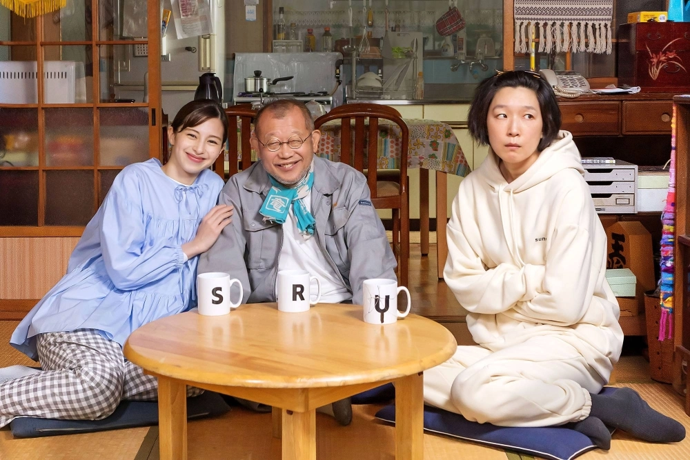 Discomfort and life lessons ensue after a 60-something-year-old man (Shofukutei Tsurube, center) marries a much younger woman (Ayami Nakajo, left) while living with his 39-year-old daughter (Noriko Eguchi) in “Amalock.” Discomfort and life lessons ensue after a 60-something-year-old man (Shofukutei Tsurube, center) marries a much younger woman (Ayami Nakajo, left) while living with his 39-year-old daughter (Noriko Eguchi) in “Amalock.”