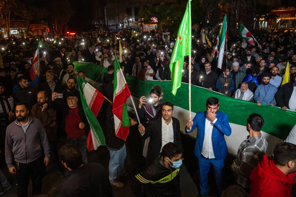Iranians gather at Palestine Square to celebrate Iran’s attack on Israel, holding up their phones with the flash on, in Tehran on Sunday. Iranians gather at Palestine Square to celebrate Iran’s attack on Israel, holding up their phones with the flash on, in Tehran on Sunday.
