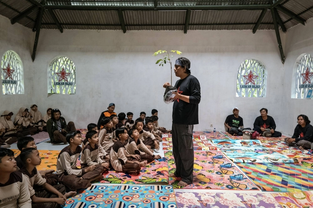 Aak Abdullah Al-Kudus, an environmentalist in East Java Province, discusses tree planting at an elementary school in Lumajang, East Java, Indonesia, in December 2023. A fatwa was issued against Aak after he tried to combine a tree-planting campaign with celebration of the Prophet Muhammad’s birthday. Aak Abdullah Al-Kudus, an environmentalist in East Java Province, discusses tree planting at an elementary school in Lumajang, East Java, Indonesia, in December 2023. A fatwa was issued against Aak after he tried to combine a tree-planting campaign with celebration of the Prophet Muhammad’s birthday.