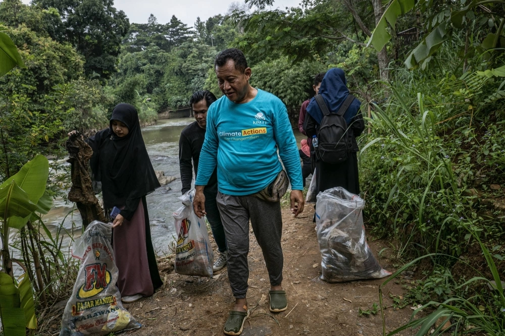 Hayu Prabowo, the head of environmental protection at the Indonesian Ulema Council, cleans up the banks of the Cikeas River with community members in Bogor, West Java, Indonesia, in December 2023. Prabowo said people “listen to religious leaders because their religious leaders say 'You can escape worldly laws, but you cannot escape God’s laws.'” Hayu Prabowo, the head of environmental protection at the Indonesian Ulema Council, cleans up the banks of the Cikeas River with community members in Bogor, West Java, Indonesia, in December 2023. Prabowo said people “listen to religious leaders because their religious leaders say 'You can escape worldly laws, but you cannot escape God’s laws.'”