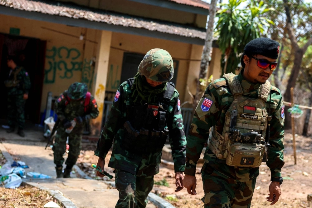 Lt. Saw Kaw, a soldier of the Karen National Liberation Army in charge of the Cobra column, walks with his team members after inspecting the house of a high-rank Myanmar soldier at Infantry Batallion 275 at Myawaddy in Myanmar on Monday. Lt. Saw Kaw, a soldier of the Karen National Liberation Army in charge of the Cobra column, walks with his team members after inspecting the house of a high-rank Myanmar soldier at Infantry Batallion 275 at Myawaddy in Myanmar on Monday.
