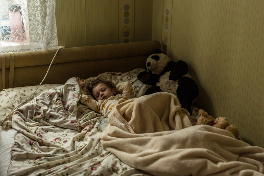 Lizi Haidarzhy, whose mother and 4-month-old brother, Tymofii, were killed in a Russian drone attack, wakes up from a nap in Odesa, Ukraine. Lizi Haidarzhy, whose mother and 4-month-old brother, Tymofii, were killed in a Russian drone attack, wakes up from a nap in Odesa, Ukraine.