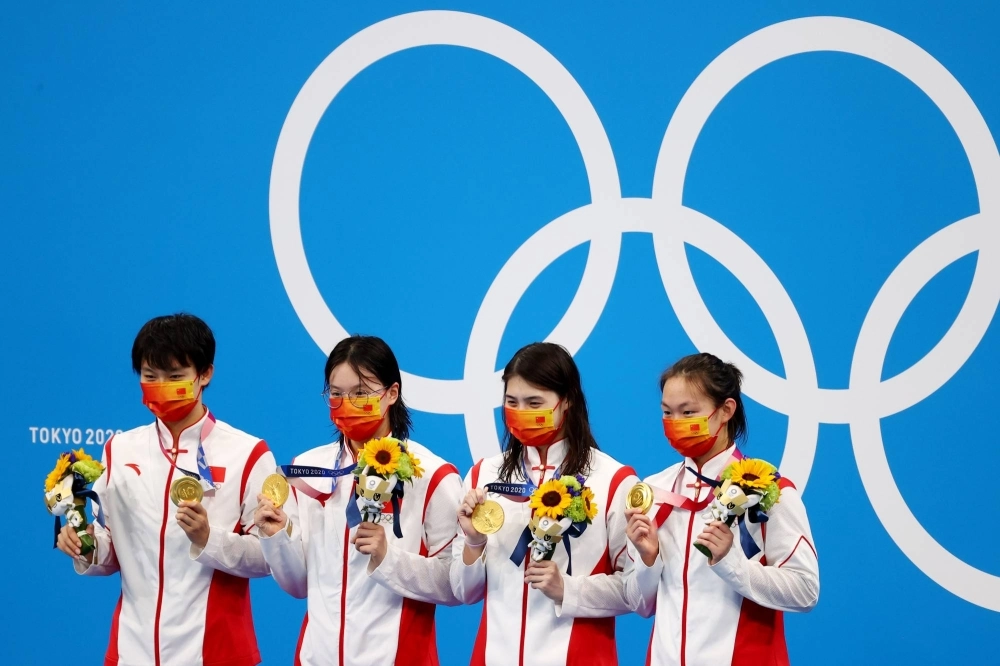China's Olympic gold-medal winning 4 x 200 meter freestyle relay team celebrates on the podium at the Tokyo Aquatics Centre on July 29, 2021.  Zhang Yufei (third from left) is among 23 top Chinese swimmers who tested positive for a banned substance in the lead up to the Games.   China's Olympic gold-medal winning 4 x 200 meter freestyle relay team celebrates on the podium at the Tokyo Aquatics Centre on July 29, 2021.  Zhang Yufei (third from left) is among 23 top Chinese swimmers who tested positive for a banned substance in the lead up to the Games.