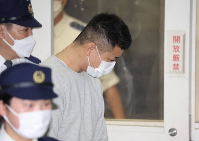 Ryoken Hirayama, a construction worker arrested in connection with the discovery of the two charred bodies in Tochigi Prefecture, leaves a Tokyo police station on Monday. He has been handed over to prosecutors. Ryoken Hirayama, a construction worker arrested in connection with the discovery of the two charred bodies in Tochigi Prefecture, leaves a Tokyo police station on Monday. He has been handed over to prosecutors.