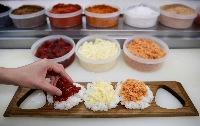 An employee at a restaurant in Tokyo makes rice balls. | Reuters