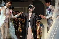 Japanese fashion designer Yumi Katsura (center) greets guests during the finale of the 2015 Yumi Katsura Grand Collection in Tokyo. Katsura has died at the age of 94. | AFP-JIJI