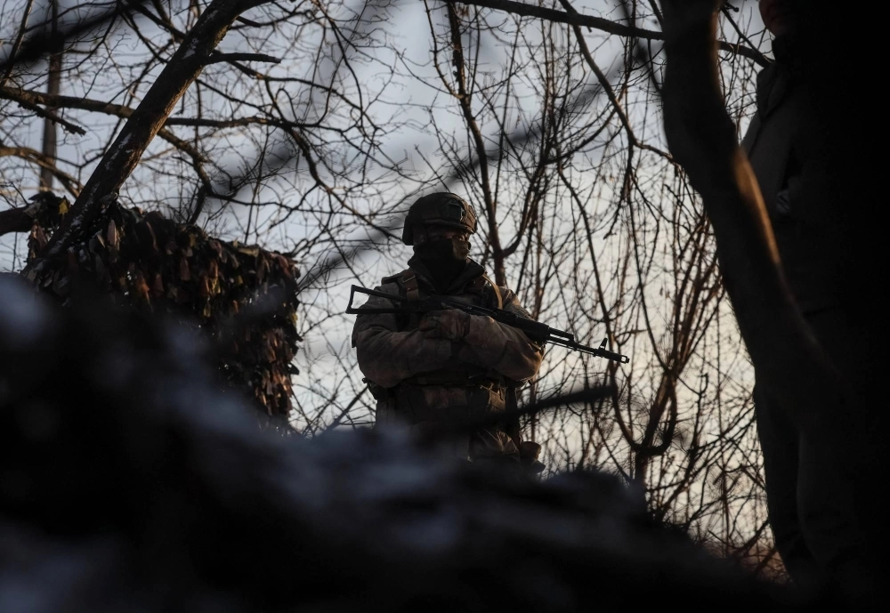 A Ukrainian serviceman stands guard at his position in a trench at a front line on the border with Russia, amid Russia's attack on Ukraine, in Sumy region, Ukraine, on Jan. 20. A Ukrainian serviceman stands guard at his position in a trench at a front line on the border with Russia, amid Russia's attack on Ukraine, in Sumy region, Ukraine, on Jan. 20.