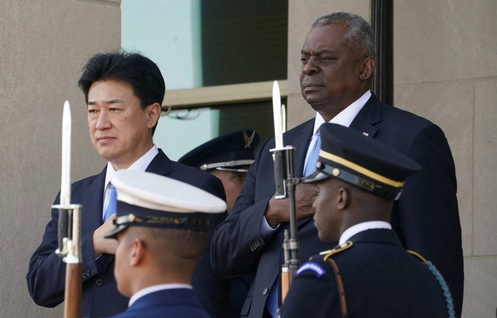 Defense Minister Minoru Kihara takes part in an arrival ceremony with U.S. Secretary of Defense Lloyd Austin at the Pentagon in Washington last October. Defense Minister Minoru Kihara takes part in an arrival ceremony with U.S. Secretary of Defense Lloyd Austin at the Pentagon in Washington last October.