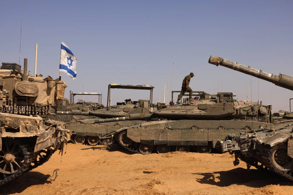 Israeli tanks sit near a border crossing to the southern Gaza Strip, in Israel, on Sunday. Israeli tanks sit near a border crossing to the southern Gaza Strip, in Israel, on Sunday.