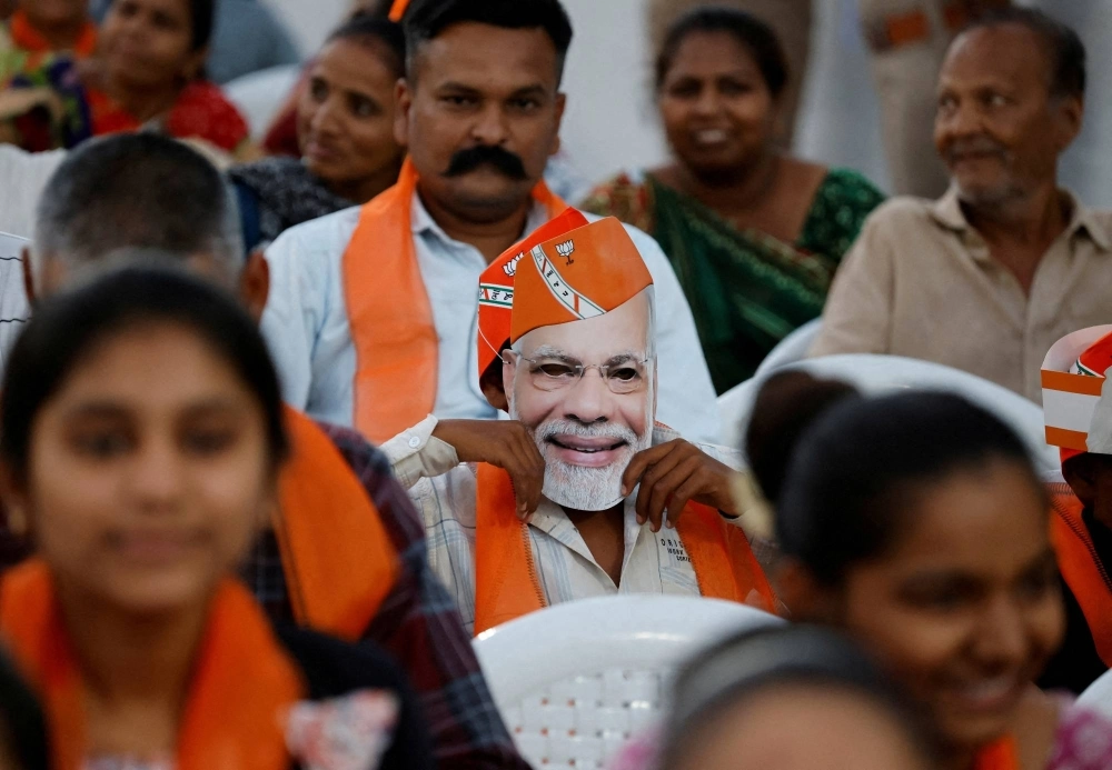 A supporter wears a mask depicting Indian Prime Minister Narendra Modi during an election campaign rally for Amit Shah, the Indian Home Minister and a leader of India's ruling Bharatiya Janata Party (BJP), in the city of Ahmedabad, in the Indian state of Gujarat, on April 30. A supporter wears a mask depicting Indian Prime Minister Narendra Modi during an election campaign rally for Amit Shah, the Indian Home Minister and a leader of India's ruling Bharatiya Janata Party (BJP), in the city of Ahmedabad, in the Indian state of Gujarat, on April 30.