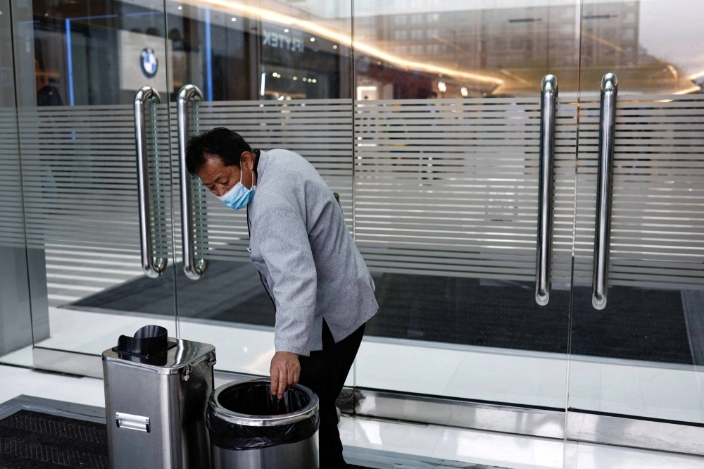 Cleaning worker Hu Dexi, 67, at a shopping mall in Beijing on April 10 Cleaning worker Hu Dexi, 67, at a shopping mall in Beijing on April 10