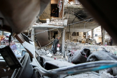 A Palestinian man leaves a house hit by an Israeli strike in Rafah, in the southern Gaza Strip, on Thursday. A Palestinian man leaves a house hit by an Israeli strike in Rafah, in the southern Gaza Strip, on Thursday.