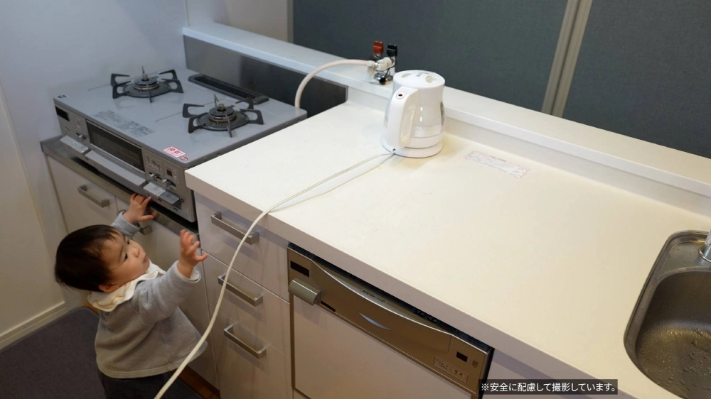 A toddler tries to pull an electric kettle cord. Parents can often recognize the dangers within their own home, but may not be as vigilant when visiting new places during the holidays. A toddler tries to pull an electric kettle cord. Parents can often recognize the dangers within their own home, but may not be as vigilant when visiting new places during the holidays.