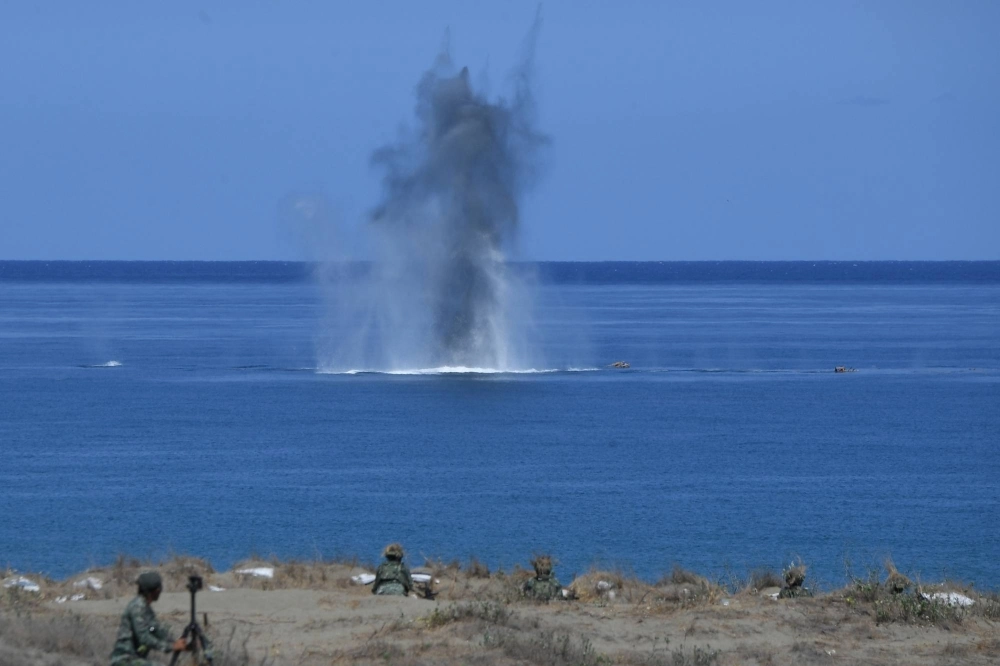 Philippine and U.S. Marines watch as a projectile hits a target at sea during a live-fire exercise against an imaginary "invasion" force as part of the annual joint military drills, on a strip of sand dunes in Laoag on Luzon island's northwest coast, on May 6. Philippine and U.S. Marines watch as a projectile hits a target at sea during a live-fire exercise against an imaginary "invasion" force as part of the annual joint military drills, on a strip of sand dunes in Laoag on Luzon island's northwest coast, on May 6.