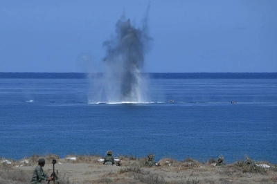 Philippine and U.S. Marines watch as a projectile hits a target at sea during a live-fire exercise against an imaginary "invasion" force as part of the annual joint military drills, on a strip of sand dunes in Laoag on Luzon island's northwest coast, on May 6. Philippine and U.S. Marines watch as a projectile hits a target at sea during a live-fire exercise against an imaginary "invasion" force as part of the annual joint military drills, on a strip of sand dunes in Laoag on Luzon island's northwest coast, on May 6.