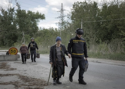 Evacuees from the Ukrainian village of Liptsi, near the Russian border, arrive at an evacuation point in the Kharkiv region of Ukraine on Sunday. Evacuees from the Ukrainian village of Liptsi, near the Russian border, arrive at an evacuation point in the Kharkiv region of Ukraine on Sunday.
