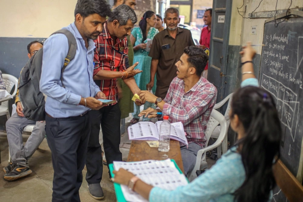 Voters register at a polling station in Gujarat, India, on May 7. Voters register at a polling station in Gujarat, India, on May 7.