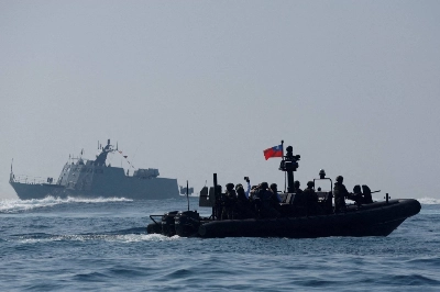 Members of Taiwan's Navy and media onboard a special operation boat navigate near a Kuang Hua VI-class missile boat, during part of a demonstration for the media to show combat readiness ahead of the Lunar New Year holidays, on the waters near a military base in Kaohsiung, Taiwan, on Jan. 31. Members of Taiwan's Navy and media onboard a special operation boat navigate near a Kuang Hua VI-class missile boat, during part of a demonstration for the media to show combat readiness ahead of the Lunar New Year holidays, on the waters near a military base in Kaohsiung, Taiwan, on Jan. 31.