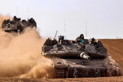 Israeli army battle tanks move near the border with the Gaza Strip at a location in southern Israel on Monday. Israeli army battle tanks move near the border with the Gaza Strip at a location in southern Israel on Monday.