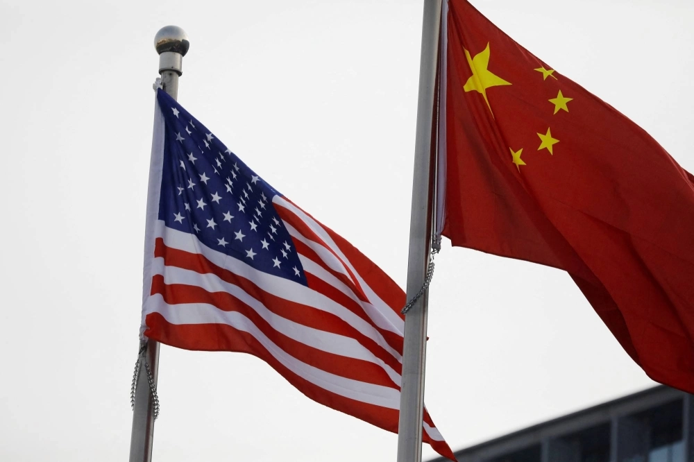 Chinese and U.S. flags flutter outside the building of an American company in Beijing. Chinese and U.S. flags flutter outside the building of an American company in Beijing.