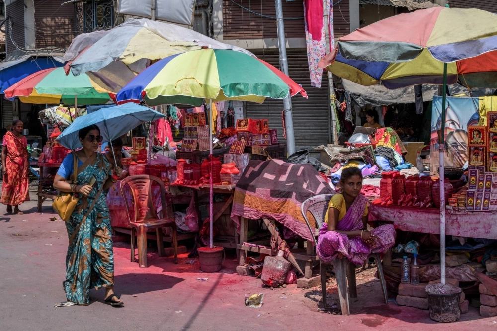 Vendors protect themselves from the scorching heat and sun by using big shades and umbrellas in the Kalighat Temple area of Kolkata, India. The city is facing multiple extreme heat days this summer and citizens are trying to find ways to cope with the weather. Vendors protect themselves from the scorching heat and sun by using big shades and umbrellas in the Kalighat Temple area of Kolkata, India. The city is facing multiple extreme heat days this summer and citizens are trying to find ways to cope with the weather.