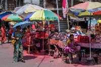 Vendors protect themselves from the scorching heat and sun by using big shades and umbrellas in the Kalighat Temple area of Kolkata, India. The city is facing multiple extreme heat days this summer and citizens are trying to find ways to cope with the weather. | Bloomberg
