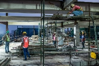 Construction workers during an evening shift in Kolkata on May 2 | Bloomberg
