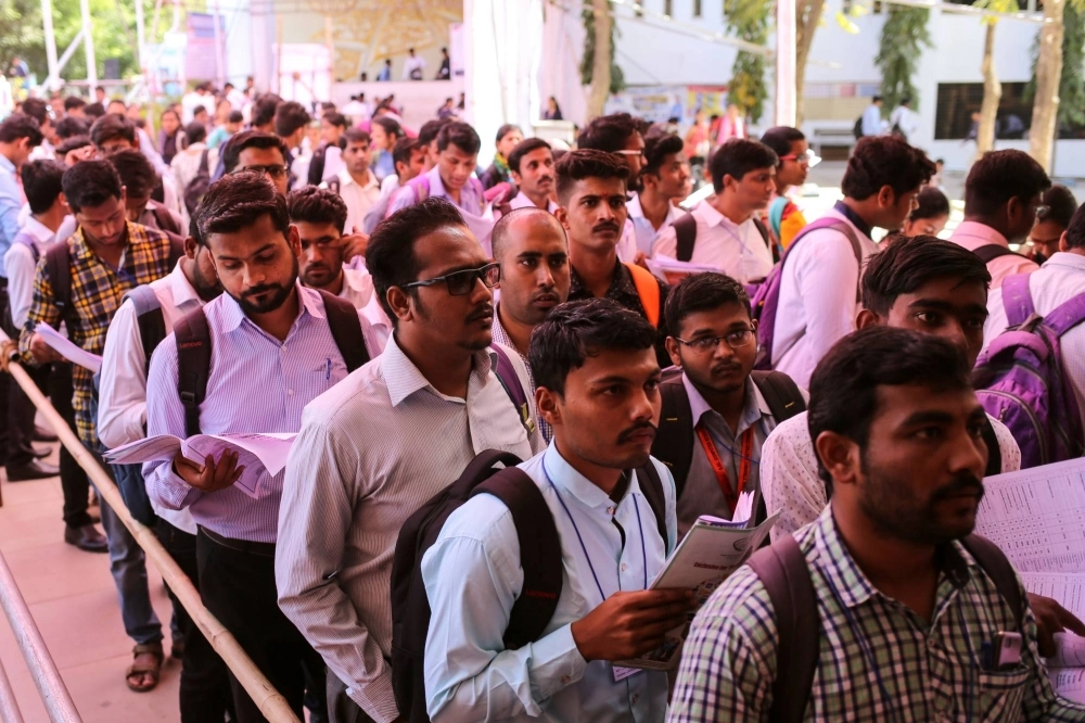 Job-seekers line up for interviews at a job fair in Chinchwad, India, in 2019. Job-seekers line up for interviews at a job fair in Chinchwad, India, in 2019.