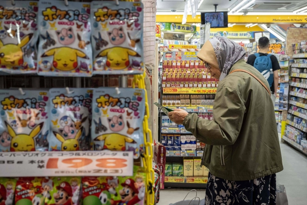A tourist shops at a drug store in the Asakusa district of Tokyo on April 30. A tourist shops at a drug store in the Asakusa district of Tokyo on April 30.