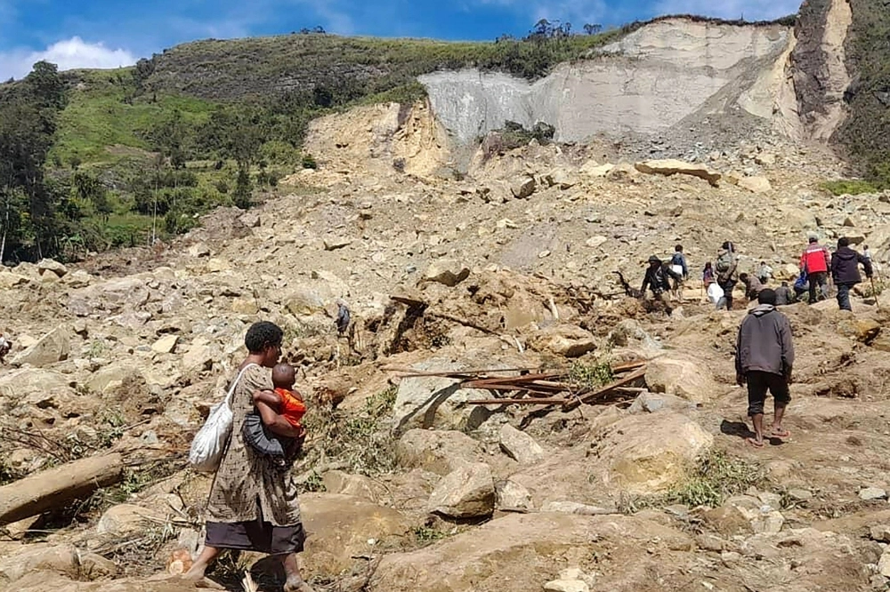 This handout photo taken on May 28 shows locals digging at the site of a landslide at Yambali village in the region of Maip Mulitaka, in Papua New Guinea's Enga Province. This handout photo taken on May 28 shows locals digging at the site of a landslide at Yambali village in the region of Maip Mulitaka, in Papua New Guinea's Enga Province.