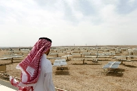 A Saudi man looks at a solar plant in Uyayna, north of Riyadh, in 2018. | REUTERS