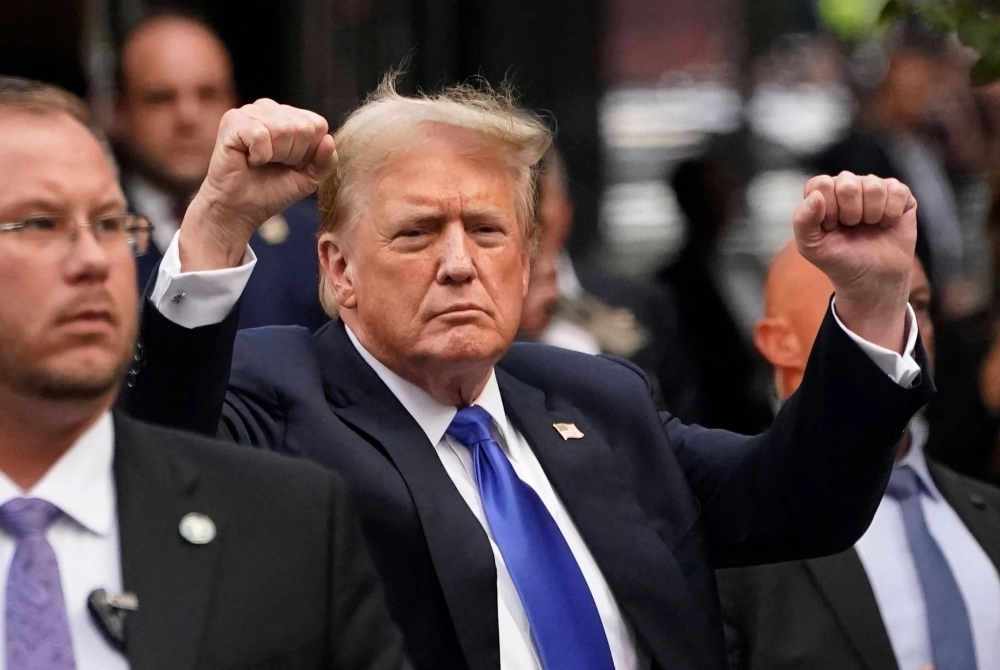 Former U.S. President and Republican presidential candidate Donald Trump gestures as he arrives back at Trump Tower after being convicted in his criminal trial, in New York City on Thursday.  Former U.S. President and Republican presidential candidate Donald Trump gestures as he arrives back at Trump Tower after being convicted in his criminal trial, in New York City on Thursday.