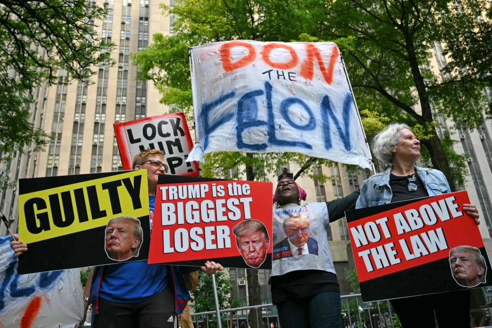 Anti-Donald Trump protesters celebrate outside the Manhattan Criminal Court where the former U.S. president was convicted Thursday in a criminal trial.   
  Anti-Donald Trump protesters celebrate outside the Manhattan Criminal Court where the former U.S. president was convicted Thursday in a criminal trial.