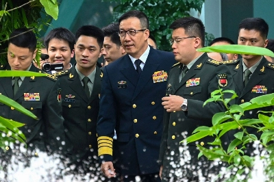 Chinese Defense Minister Dong Jun (center) arrives with his delegation for a bilateral meeting with U.S. Secretary of Defense Lloyd Austin on the sidelines of the 21st Shangri-La Dialogue summit at the Shangri-La Hotel in Singapore on Friday. Chinese Defense Minister Dong Jun (center) arrives with his delegation for a bilateral meeting with U.S. Secretary of Defense Lloyd Austin on the sidelines of the 21st Shangri-La Dialogue summit at the Shangri-La Hotel in Singapore on Friday.