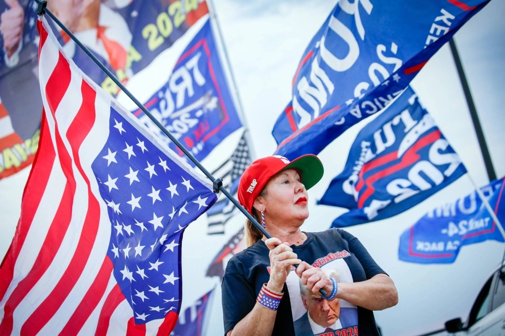 A supporter of former President Donald Trump protests in Palm Beach, Florida, after the guilty verdict over falsifying business records was announced on Thursday.  A supporter of former President Donald Trump protests in Palm Beach, Florida, after the guilty verdict over falsifying business records was announced on Thursday.