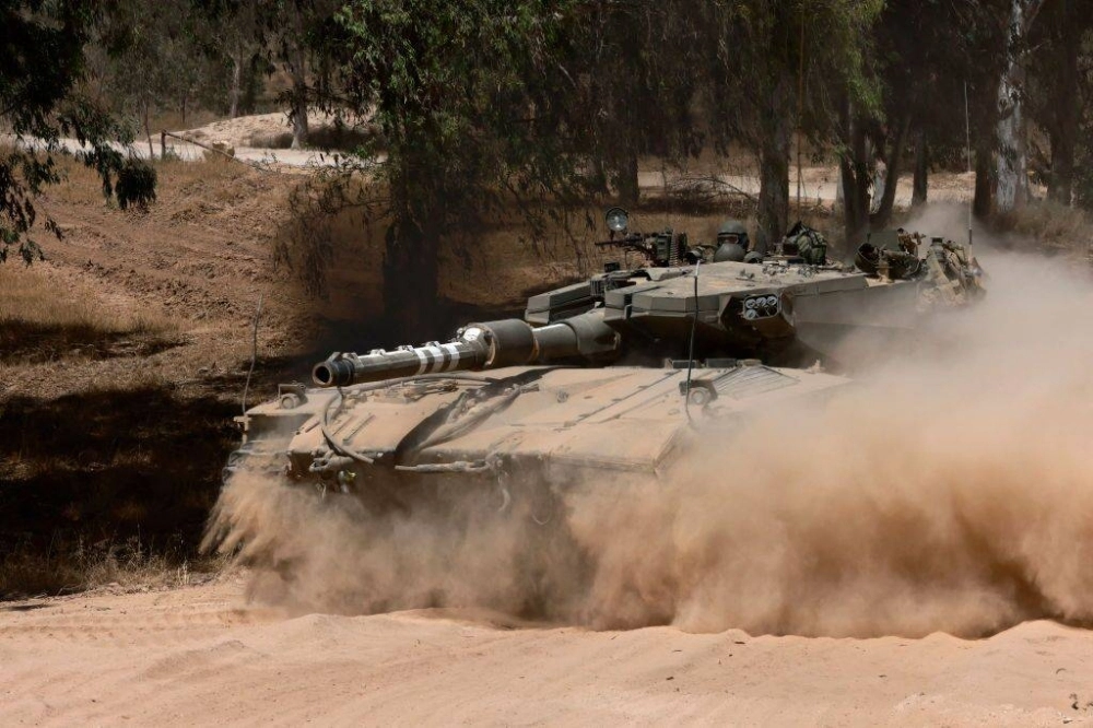 An Israeli army tank takes position in an area of Israel's southern border with the Gaza Strip on Sunday.  An Israeli army tank takes position in an area of Israel's southern border with the Gaza Strip on Sunday.